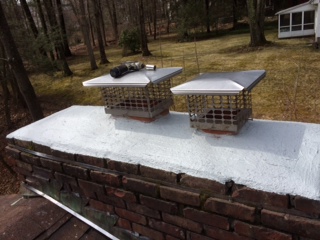 Completed crown repair with new double chimney cap installation