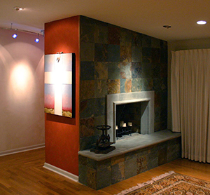 Completed prefabricated fireplace installation with tile surround and hearth