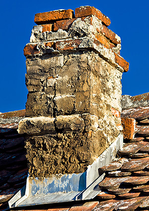 Damaged chimney masonry causing leaks before repair