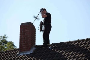 man sweeping chimney