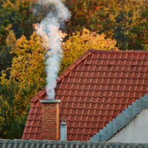 a masonry chimney with smoke coming out of it