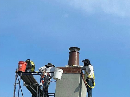 All Seasons- Original photo of technicians Technicians working on chimney